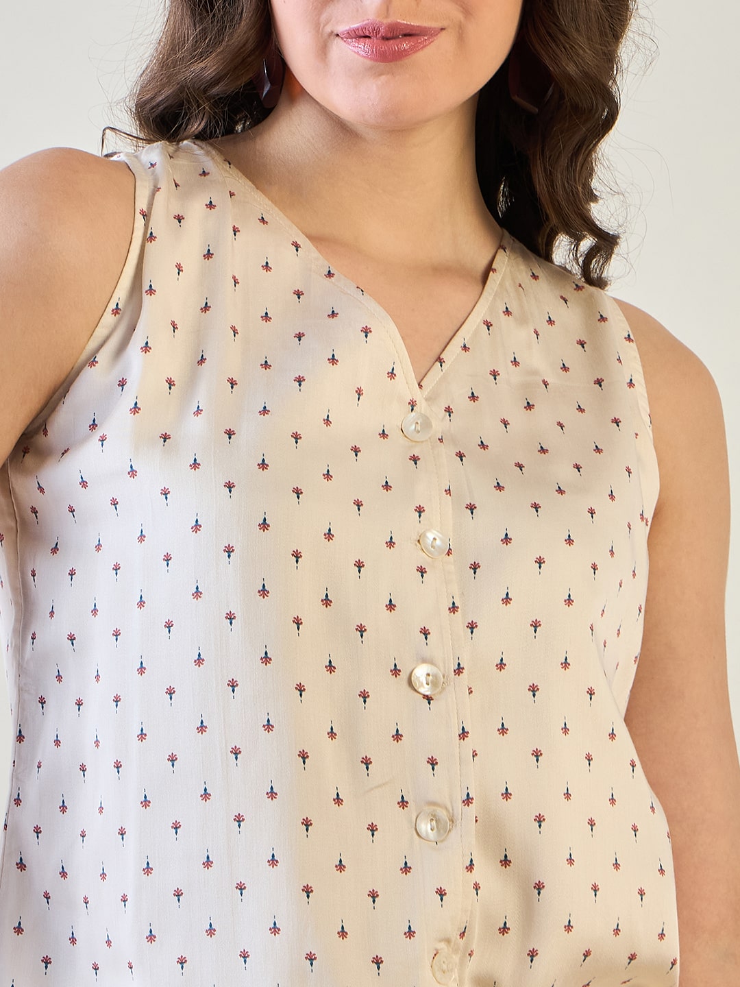 Sleeveless waistcoat top styled with matching floral pattern pants.