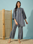 Women light denim co-ord set featuring a button-up top and wide-legged pants for a chic, casual look.
