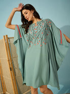 Chic green party dress with floral bead embroidery, ideal for celebrating in style.

