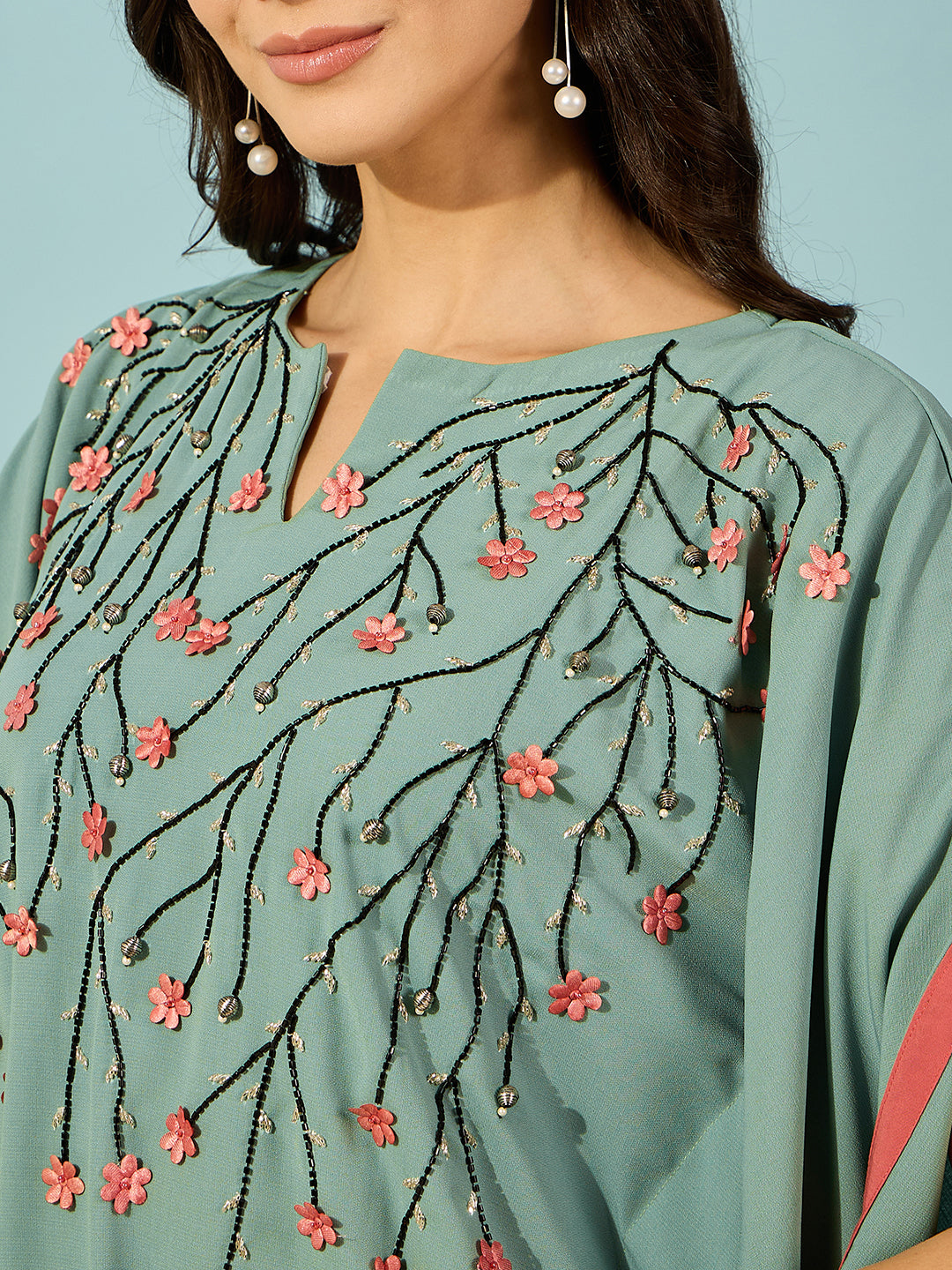 Celebrate in elegance with this green embroidered kaftan dress, featuring pink floral accents.
