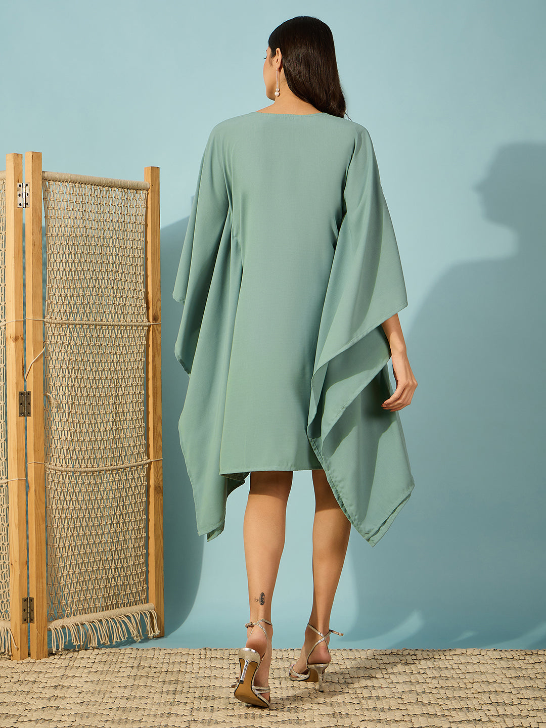 Green kaftan dress with beautiful floral bead embroidery, perfect for festive and elegant events.
