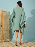 Green kaftan dress with beautiful floral bead embroidery, perfect for festive and elegant events.
