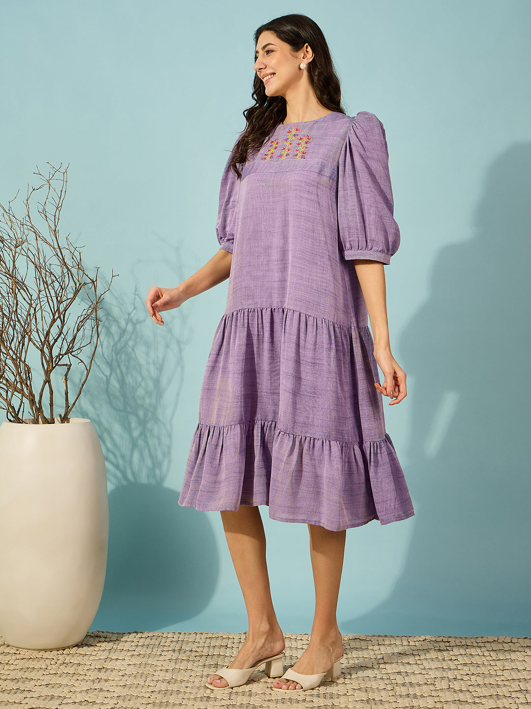 Chic purple viscose linen western dress featuring delicate hand embroidery and a tiered skirt.
