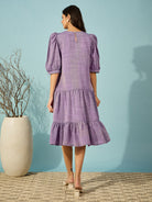 Relaxed-fit purple linen western short length dress with puffed sleeves and elegant hand embroidery.
