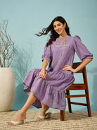Soft purple linen western dress with hand-embroidery and tiered design, ideal for every occasion.

