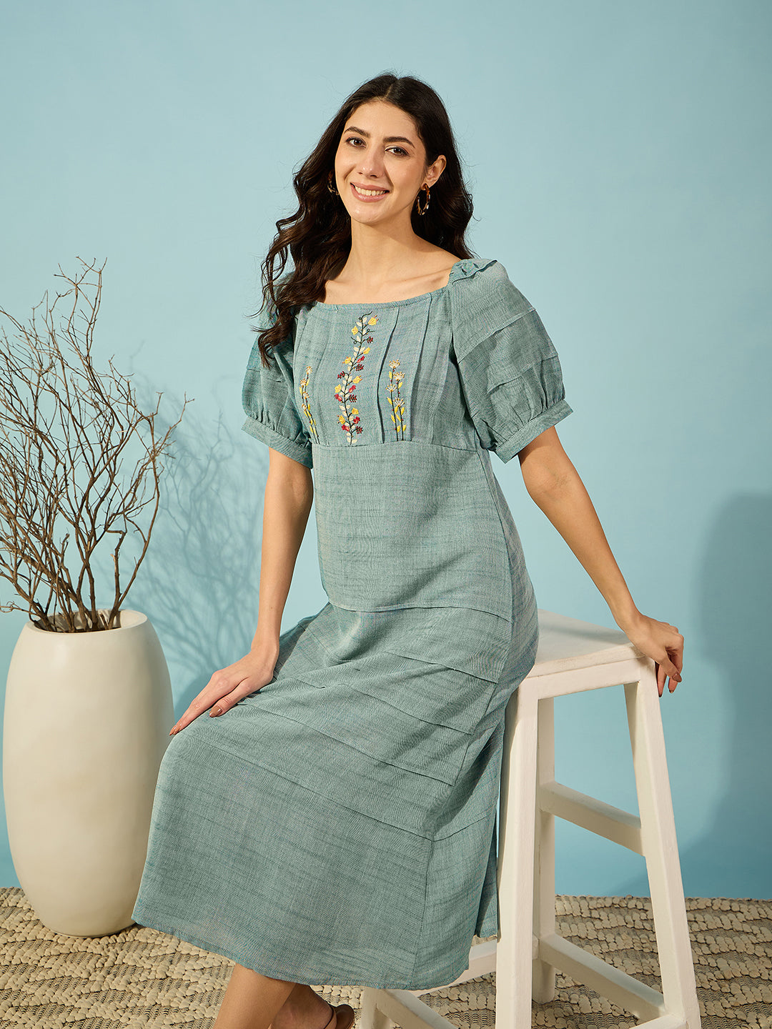 Green viscose linen midi dress with delicate floral embroidery, ideal for both casual and formal events.
