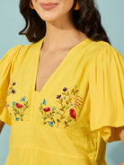 Women's knee-length yellow dress in lightweight viscose linen, adorned with exquisite hand embroidery.
