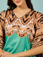 Stunning light green baroque printed satin kaftan dress with a V-neckline, offering a chic and flattering fit.
