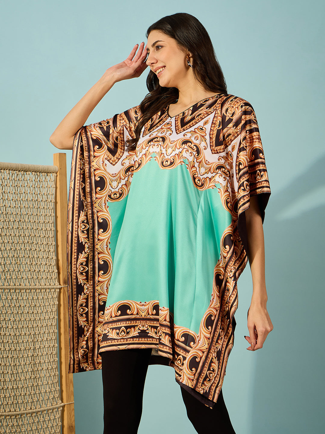 Luxurious light green satin kaftan dress with baroque print and V-neckline, ideal for evening events.

