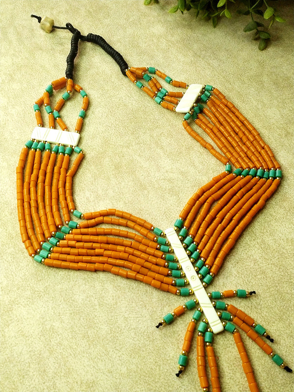 Handmade orange and blue Naga bead layered necklace that combines traditional craftsmanship with contemporary design.
