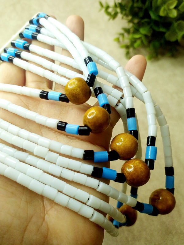 Stylish necklace crafted from white Naga beads and wooden elements, showcasing a unique design with striking blue highlights.

