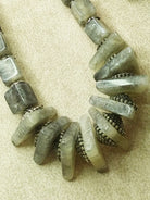 Striking grey bead necklace featuring a stunning array of grey beads, perfect for adding elegance to any outfit.
