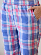 Cotton pyjama set in blue and pink checkered print, providing a comfortable and stylish option for sleep.
