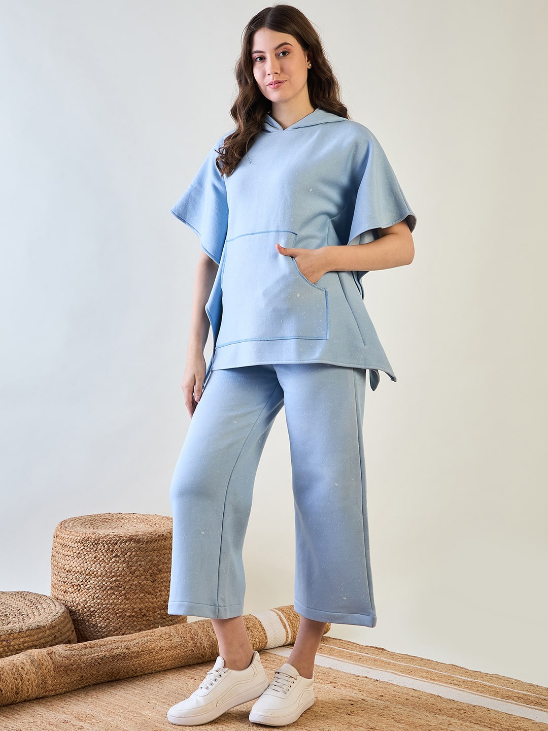 Stylish light blue kaftan paired with soft pyjamas for lounging.