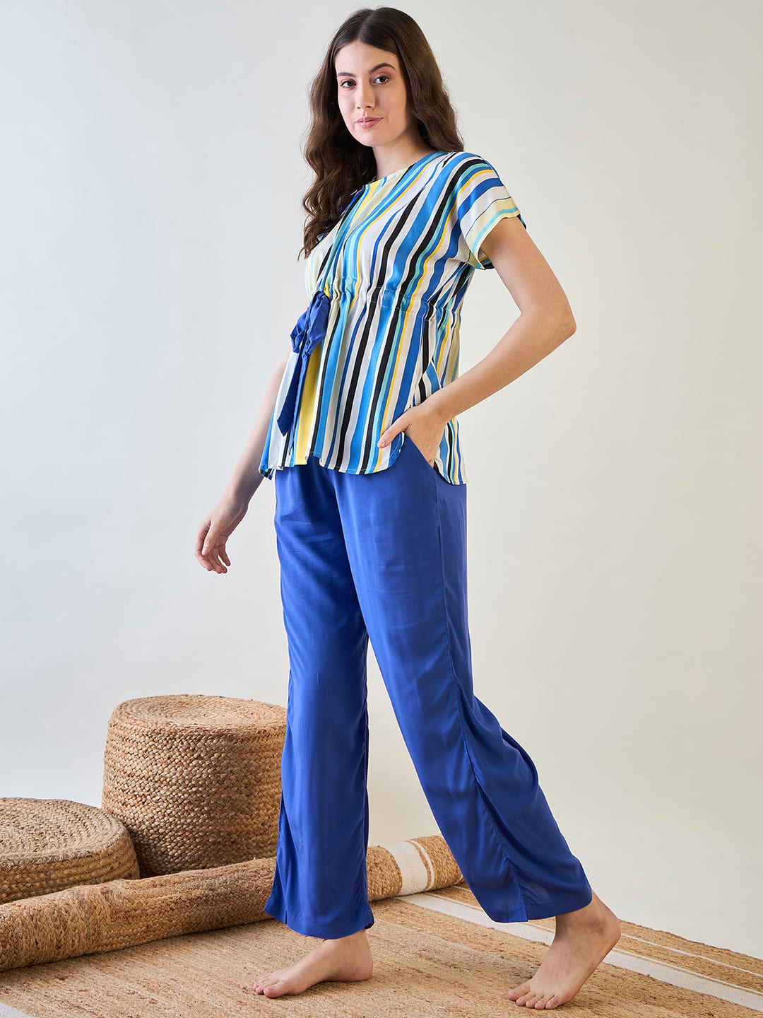 Blue pajama set featuring colorful stripes and playful tassel details.