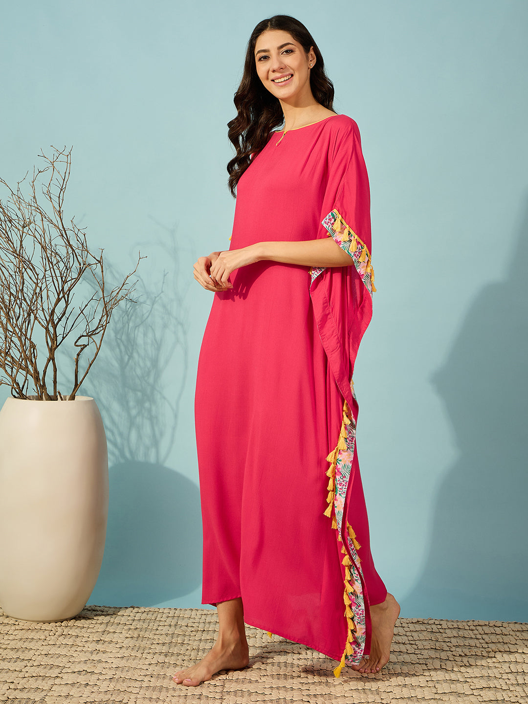 Comfy pink nightdress kaftan with yellow tassels, perfect for relaxing in style.
