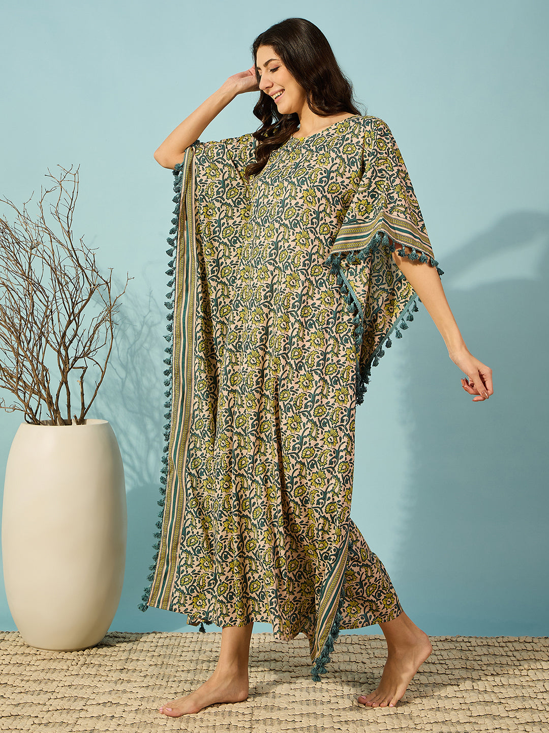 Chic and flowy yellow cotton kaftan for women, featuring vibrant floral prints and a striped border.
