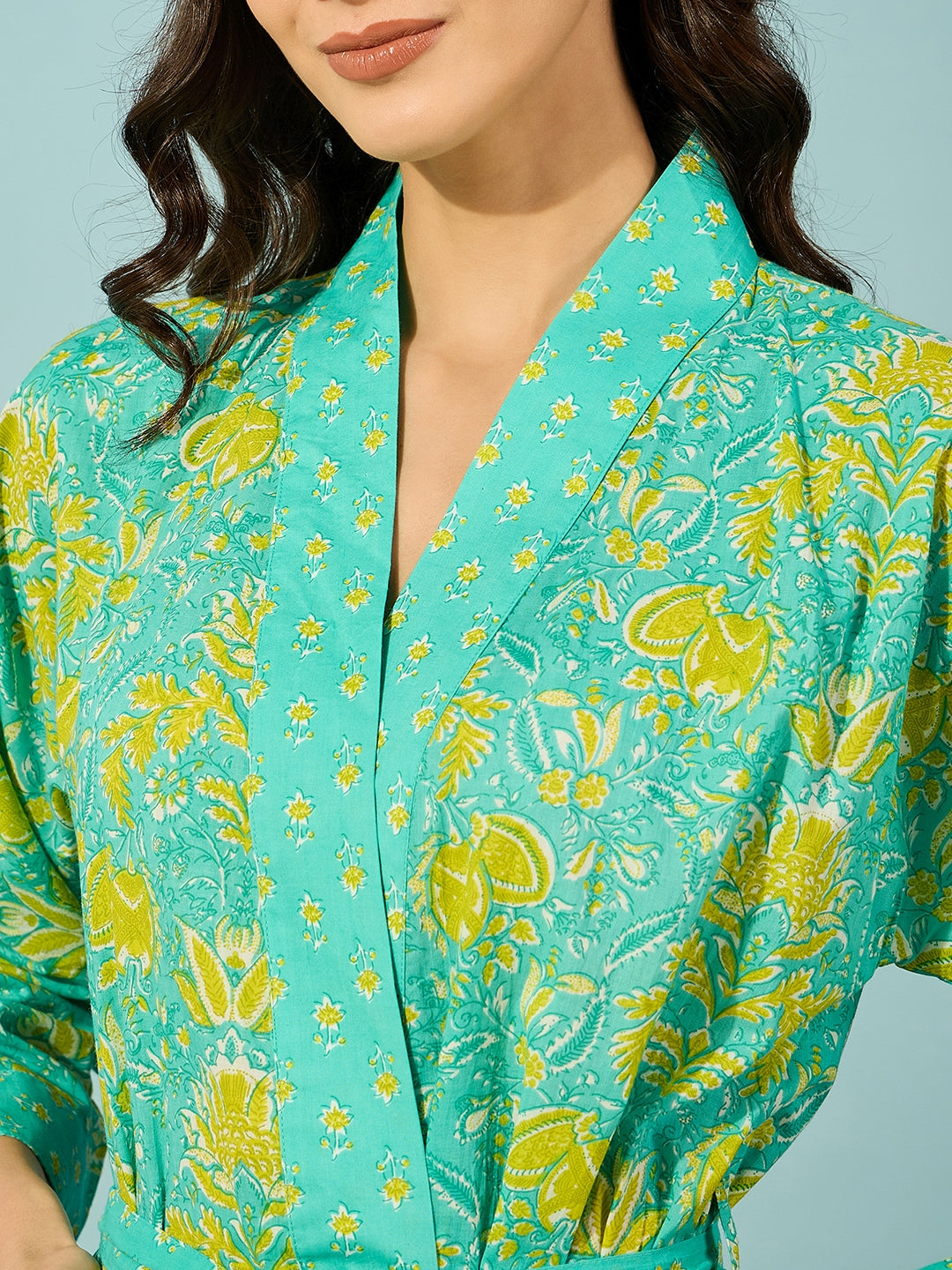 Comfortable and chic floral blue cotton gown with full sleeves and waist belt.
