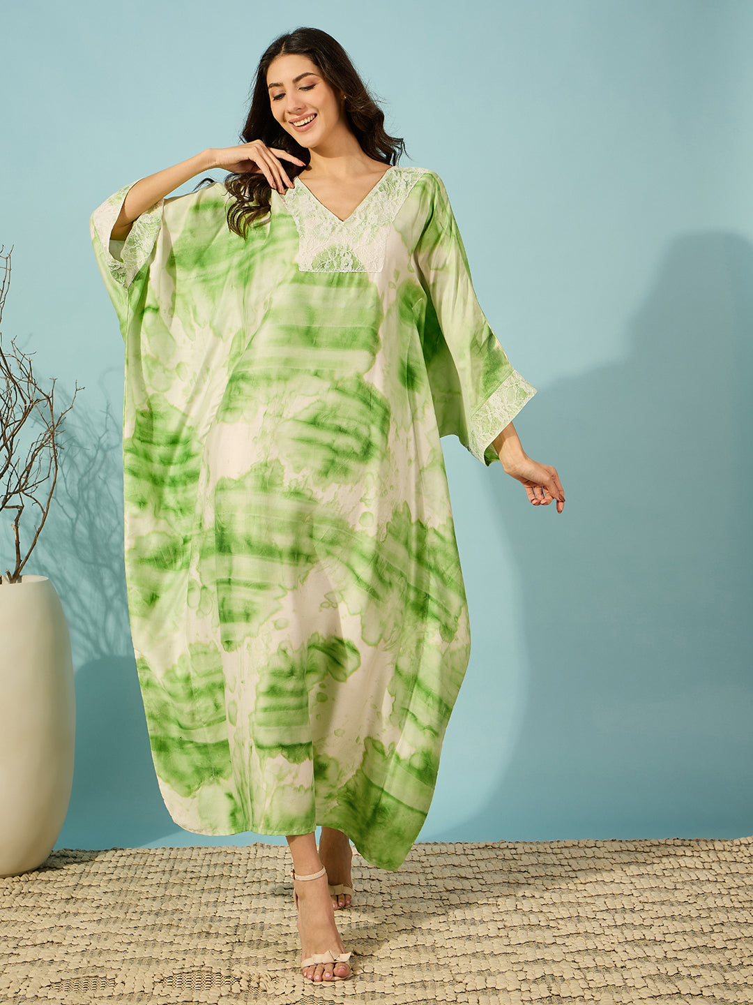 Relax in style with the soothing green tie-dye nightdress, featuring a delicate lace yoke for added elegance.
