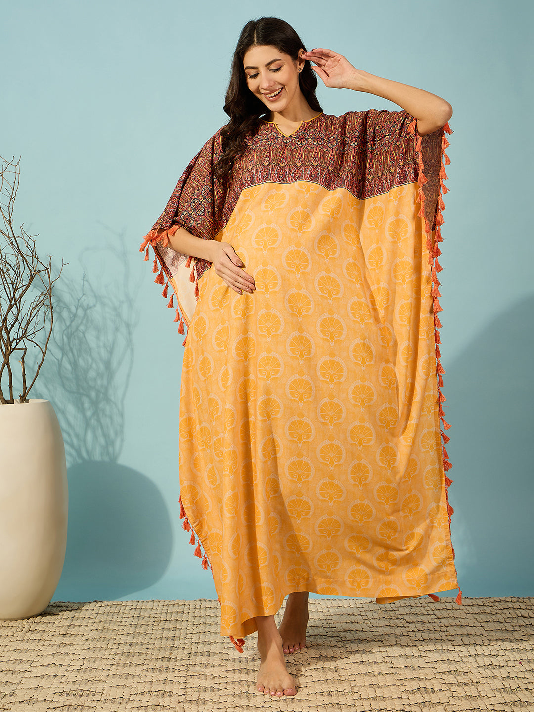 Golden Bloom Maternity Kaftan with playful tassel details, designed for comfort and elegance.
