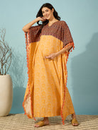 Chic and cozy maternity kaftan in golden bloom color, with fun tassel accents.
