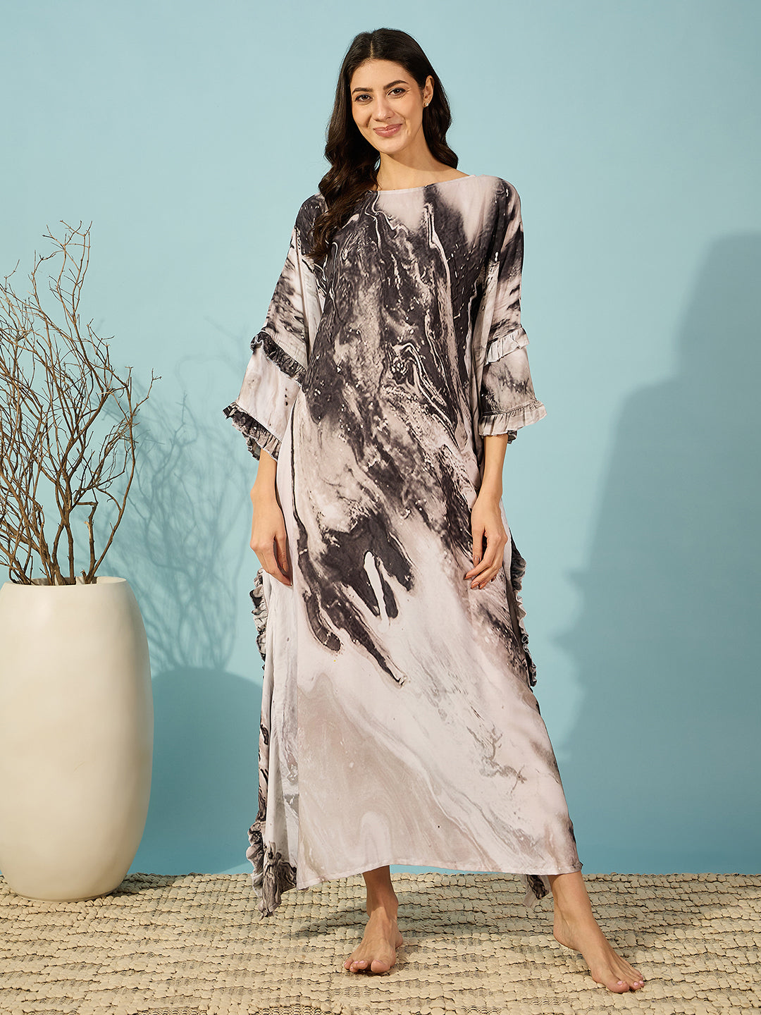 Elegant black marble kaftan dress with ruffle accents, ideal for home relaxation or casual wear.
