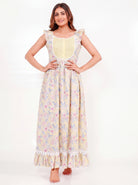 Woman wearing a yellow floral print cotton nightdress with ruffle cap sleeves, lace-trimmed bib, and flared maxi silhouette