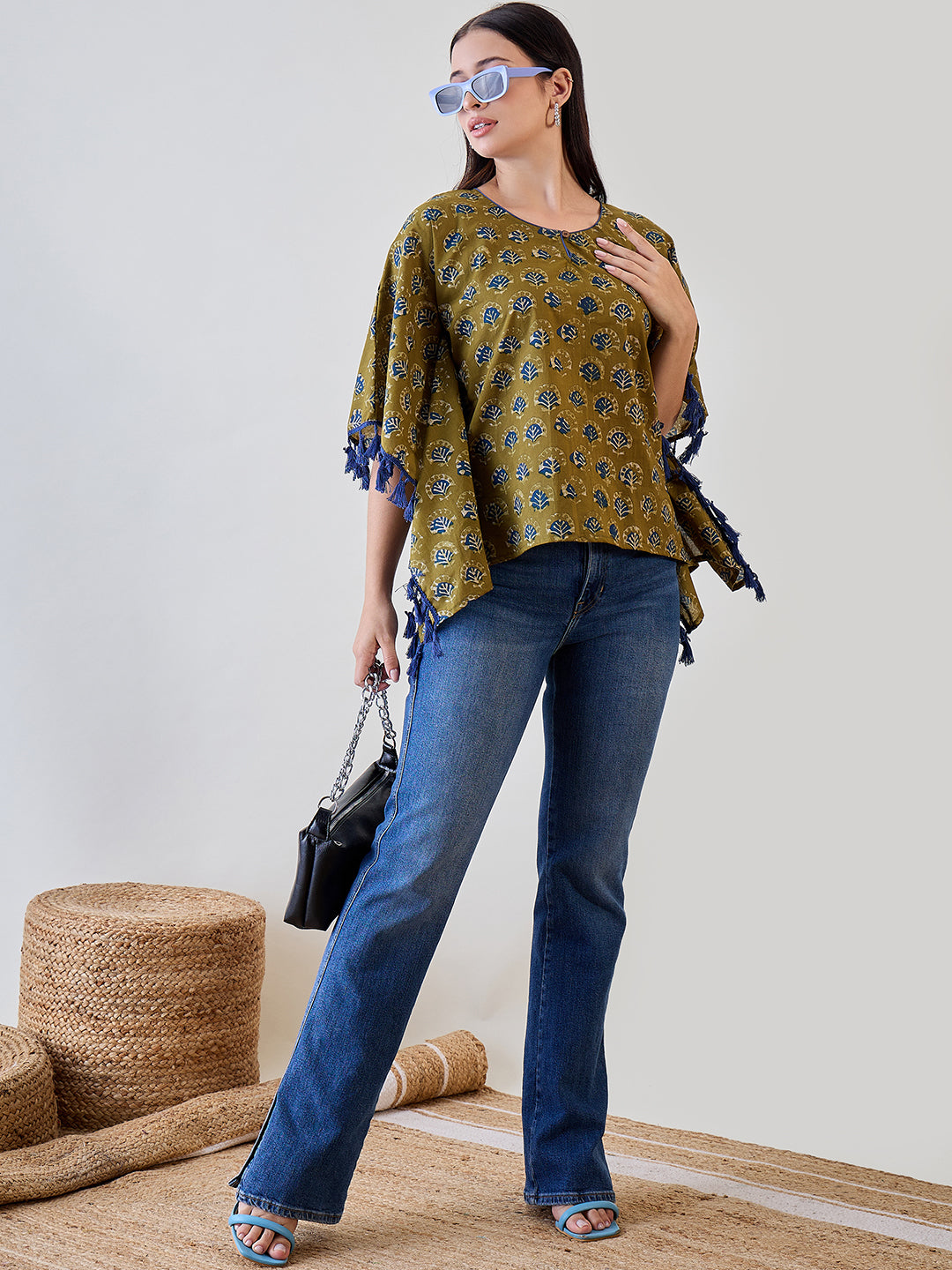 Add a touch of elegance with the Bright Blue Tasseled Green Cotton Ethnic Motifs Kaftan Top.
