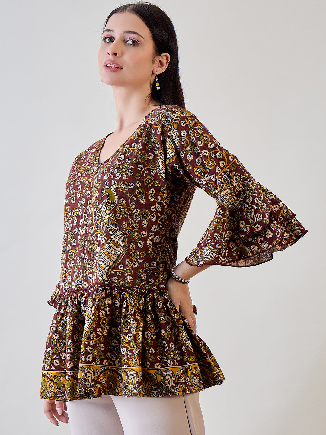 Add a touch of ethnic charm to your wardrobe with the Kalamkari Ethnic Printed Cotton Peplum Top
