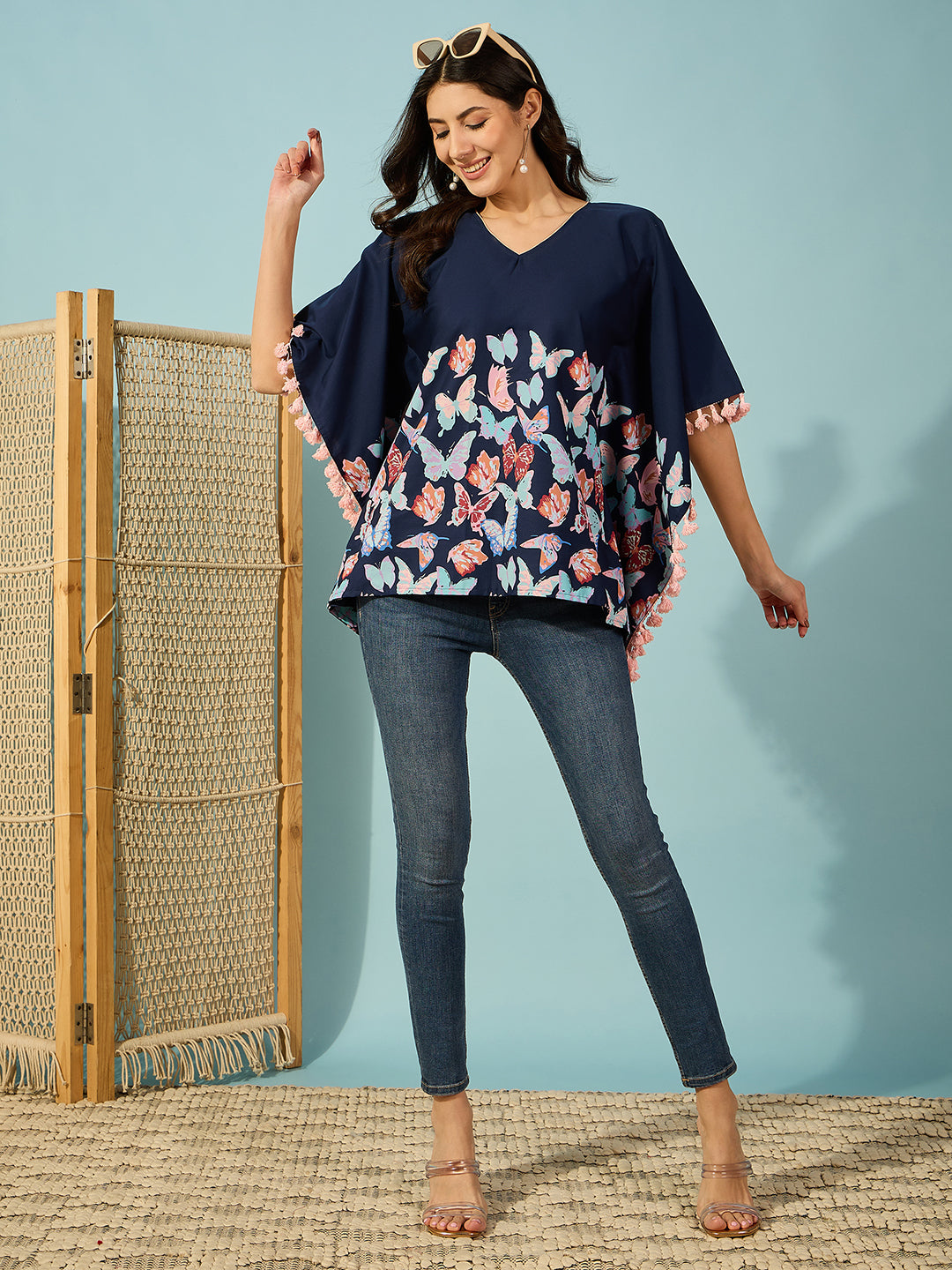 Whimsical blue cotton kaftan top featuring butterfly print and pink tassels â‚¬€œ Ideal for casual outings.
