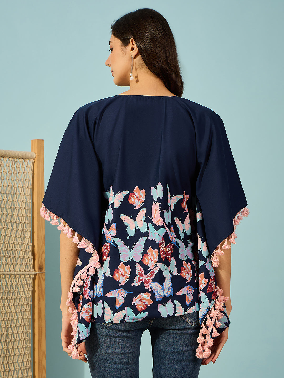 Women charming butterfly-printed cotton kaftan top with a V-neckline and playful pink tassels.
