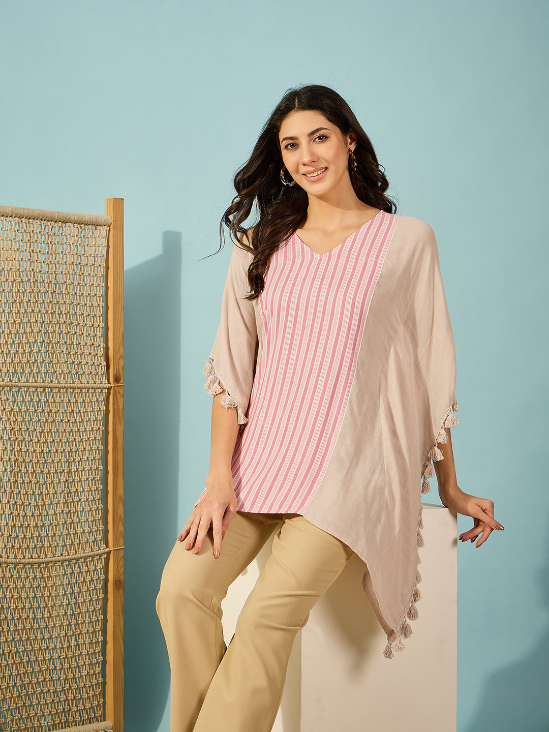 Trendy beige and pink striped kaftan top for women, featuring a slim fit and V-neckline.
