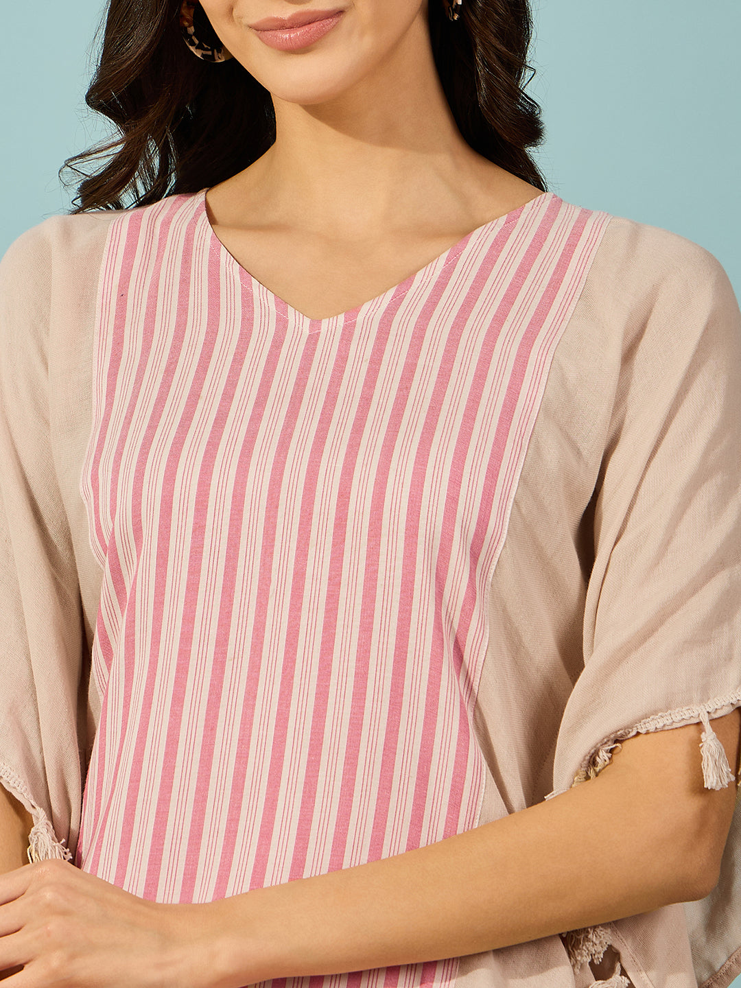 Vibrant striped cotton kaftan top, perfect for relaxed yet chic outfits, with tasseled edges.
