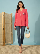 Trendy red shirt for women, featuring a mandarin collar and intricate elephant embroidery.
