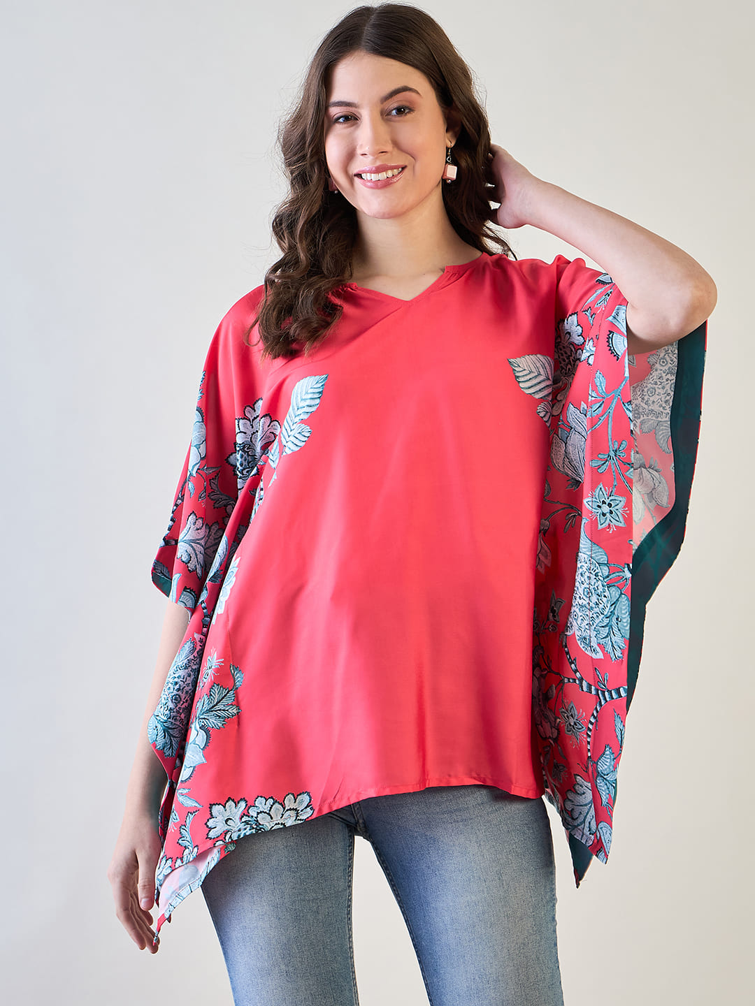Elegant redÂ floral kaftan topÂ featuring vibrantÂ floral patterns.