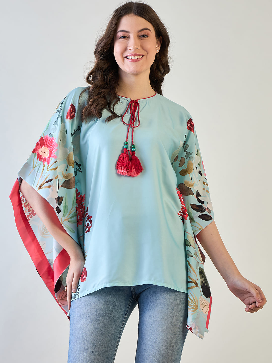 Sky blue floral kaftan top with vibrant blue flowers and short sleeves.
