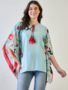 Sky blue floral kaftan top with vibrant blue flowers and short sleeves.