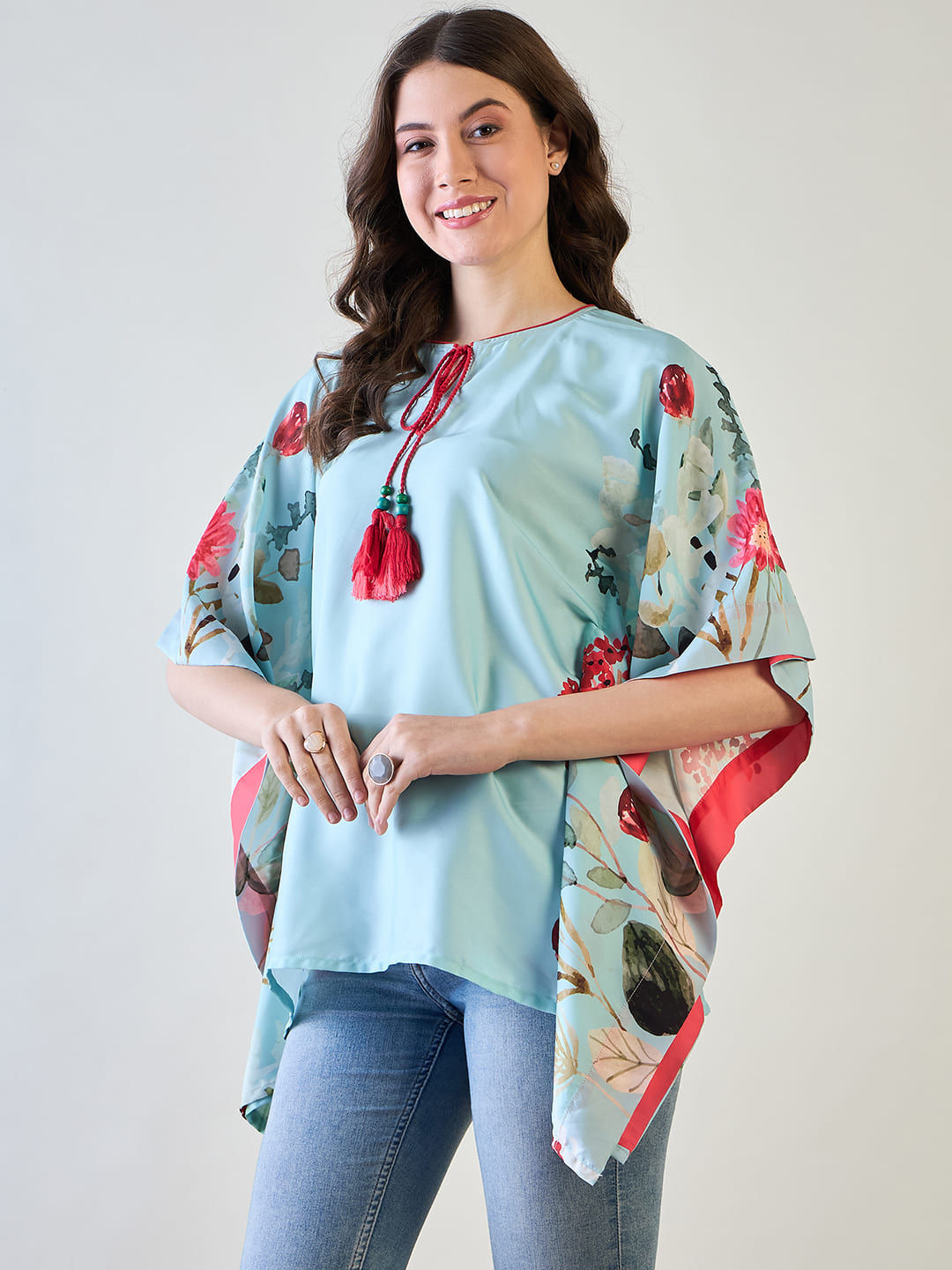 Sky blue floral kaftan top displayed against a white background to emphasize design.