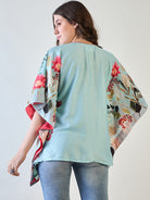 V-neck and short sleeve detail of the sky blue floral kaftan top.