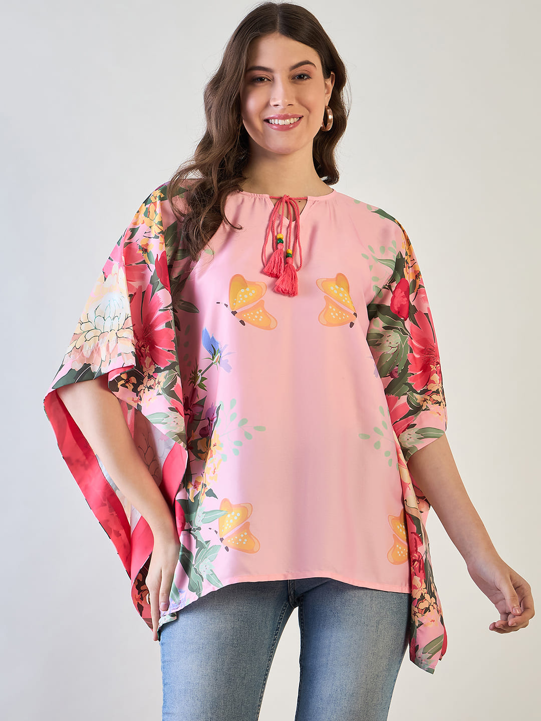 Pink and yellow floral kaftan top with butterfly designs.