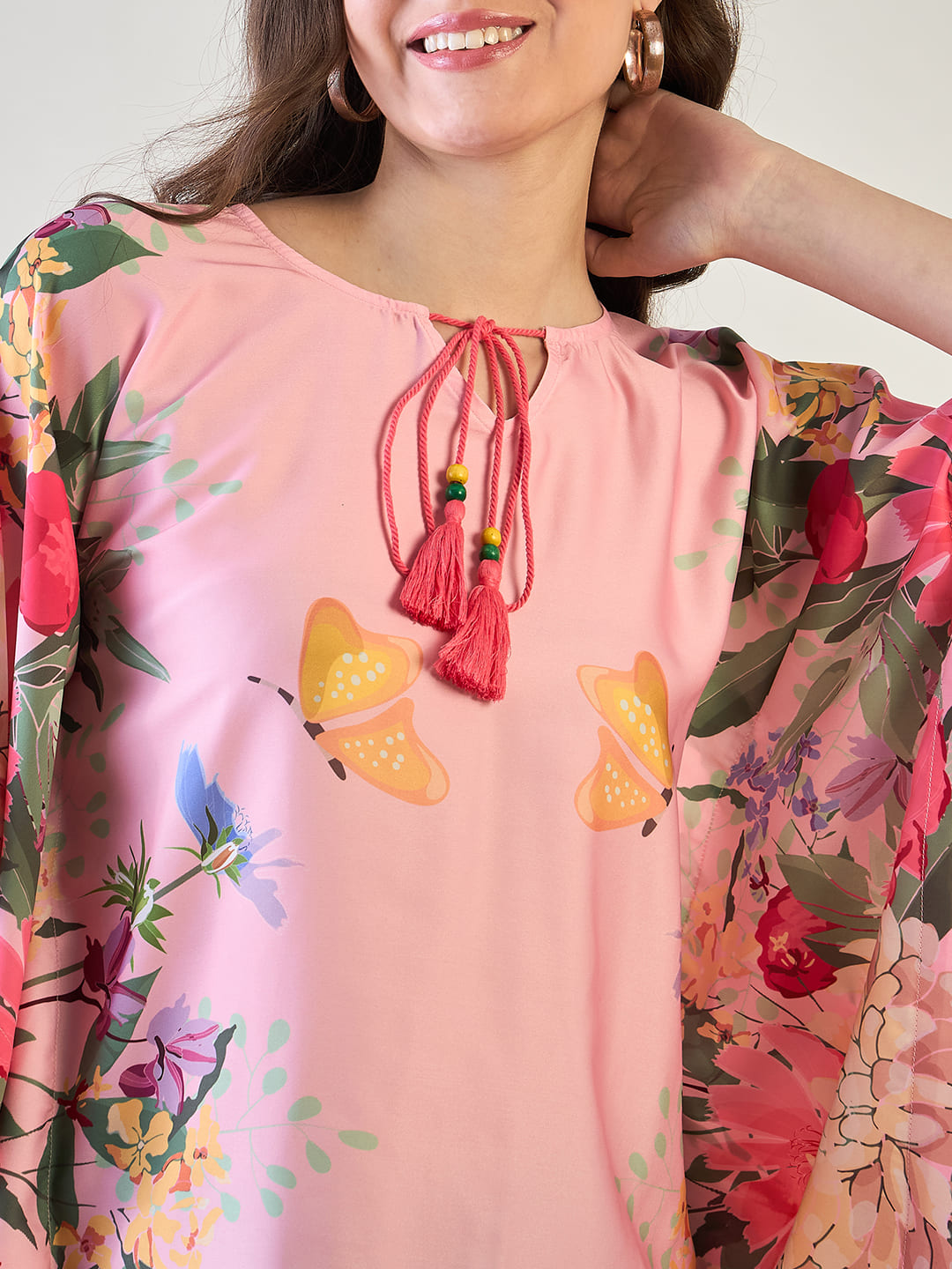 Relaxed fit floral kaftan top with short sleeves and tassel detailing.