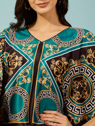 Elevate your casual wardrobe with this women's teal baroque printed kaftan-style top.
