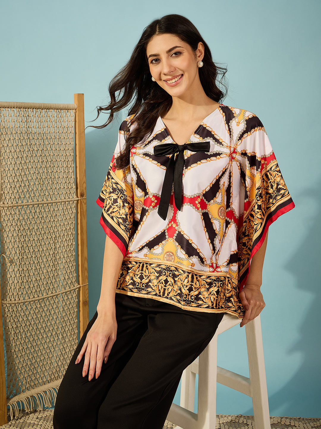 Elevate your style with a luxurious satin black kaftan top featuring intricate Baroque designs and a cute bow.
